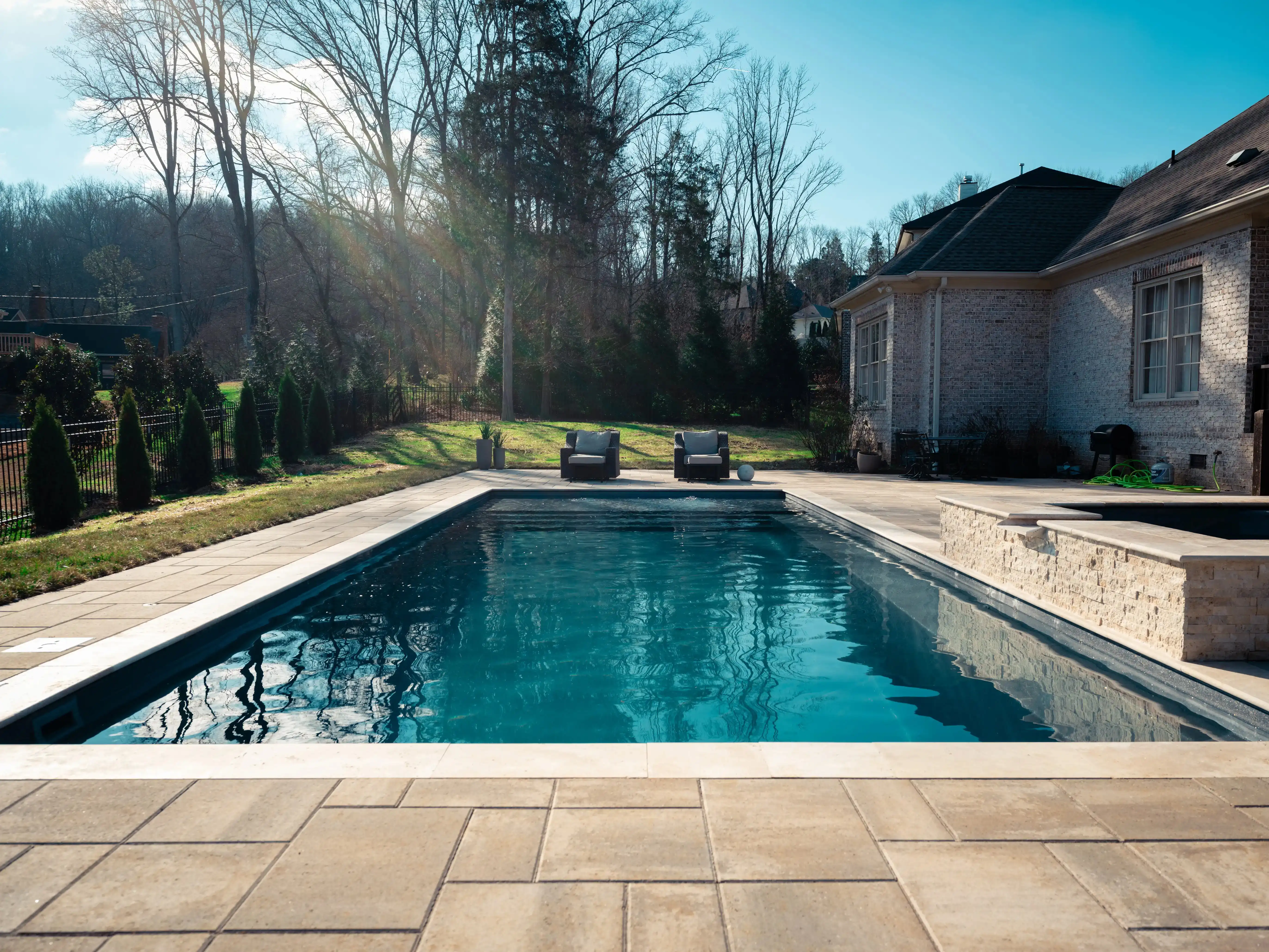 A completed Aqua Technics pool in a landscaped backyard